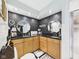 Stylish bathroom featuring double sinks with black countertops and decorative round mirrors at 12 Windridge St, Country Club Heights, IN 46011