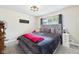 Cozy bedroom with plush gray bedding, decorative lamps, and natural light from window at 12 Windridge St, Country Club Heights, IN 46011