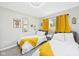 Charming bedroom featuring twin beds, bright yellow accents, and natural light at 12 Windridge St, Country Club Heights, IN 46011