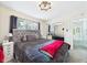 Comfortable bedroom with plush gray bedding, closet with mirrored doors and window at 12 Windridge St, Country Club Heights, IN 46011