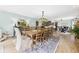 Open-concept dining area with a large table, stylish decor, and natural light is great for entertaining guests at 12 Windridge St, Country Club Heights, IN 46011