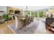 Elegant dining room with stone fireplace, large table, and access to the outdoors is great for gatherings at 12 Windridge St, Country Club Heights, IN 46011