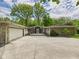 Stately stone and stucco home with large front yard and attached garage at 12 Windridge St, Country Club Heights, IN 46011