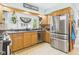Well-appointed kitchen boasting stainless steel appliances, custom cabinets, granite countertops, and natural light at 12 Windridge St, Country Club Heights, IN 46011