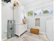Bright laundry room features ample cabinet space and charming decor at 12 Windridge St, Country Club Heights, IN 46011