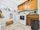Functional laundry room with wooden cabinets, washer, dryer, and ample storage space at 12 Windridge St, Country Club Heights, IN 46011