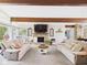 Open living room featuring a stone fireplace, comfortable sofas, and natural light creates a cozy atmosphere at 12 Windridge St, Country Club Heights, IN 46011