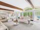 Spacious living room with large windows, plush seating, and open layout is ideal for entertaining at 12 Windridge St, Country Club Heights, IN 46011