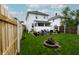 Spacious backyard featuring a patio area, fire pit, lush lawn, and privacy fence at 1207 Chestnut St, Columbus, IN 47201