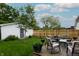 Beautiful backyard with a well-manicured lawn, patio seating, and mature trees at 1207 Chestnut St, Columbus, IN 47201
