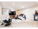 Finished basement with a comfortable seating area, entertainment center, and neutral carpet at 1207 Chestnut St, Columbus, IN 47201