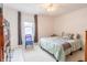 Cozy bedroom featuring a comfortable bed, a ceiling fan, and natural light from the window at 1207 Chestnut St, Columbus, IN 47201