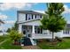 Charming two-story home with a covered front porch and beautifully landscaped yard at 1207 Chestnut St, Columbus, IN 47201