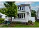 Inviting two-story home with a classic covered porch and lush, green lawn at 1207 Chestnut St, Columbus, IN 47201