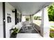 Inviting front porch featuring a comfortable swing, rocking chair, and stylish decor at 1207 Chestnut St, Columbus, IN 47201