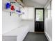 This mud room features white shiplap walls and a storage bench for both aesthetics and functionality at 1207 Chestnut St, Columbus, IN 47201