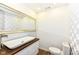 This is a modern bathroom with a white vessel sink, wood countertop, and patterned accent wall at 1212 S Senate Ave, Indianapolis, IN 46225