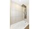 This is a bathroom with a white tub and shower with a modern shower head at 1212 S Senate Ave, Indianapolis, IN 46225