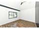 Bedroom features wood flooring, large window, and vaulted ceiling, providing bright and airy space at 1212 S Senate Ave, Indianapolis, IN 46225