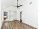 Bright bedroom features wood-look floors, a ceiling fan, windows, and a walk-in closet at 1212 S Senate Ave, Indianapolis, IN 46225