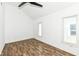 A bright bedroom features wood-look floors, a ceiling fan, and windows for natural light at 1212 S Senate Ave, Indianapolis, IN 46225