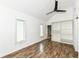 Bright bedroom features wood-look floors, a ceiling fan, windows, and built in closet at 1212 S Senate Ave, Indianapolis, IN 46225