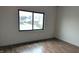 A bedroom showcasing new floors, electrical outlets, and a window overlooking the street at 1212 S Senate Ave, Indianapolis, IN 46225