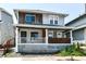 Charming two-story home featuring a cozy front porch with stylish design elements at 1212 S Senate Ave, Indianapolis, IN 46225