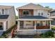 Charming two-story home featuring a cozy front porch with stylish design elements at 1212 S Senate Ave, Indianapolis, IN 46225