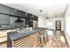 Modern kitchen island with seating, stainless steel appliances, black backsplash and cabinetry at 1212 S Senate Ave, Indianapolis, IN 46225