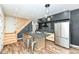 Modern kitchen island with seating, stainless steel appliances, black backsplash and cabinetry at 1212 S Senate Ave, Indianapolis, IN 46225