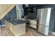 Modern kitchen with a stainless steel refrigerator, a wooden island and dark accents at 1212 S Senate Ave, Indianapolis, IN 46225