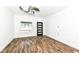 Bright living room with modern ceiling fan, laminate flooring, and lots of natural light at 1212 S Senate Ave, Indianapolis, IN 46225