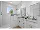 Modern bathroom with granite countertops, dual vanity, frameless mirrors, and walk-in shower with window at 1231 Marlowe Ave, Indianapolis, IN 46202
