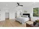 This bedroom has stylish furnishings, light wood floors, and a modern ceiling fan at 1231 Marlowe Ave, Indianapolis, IN 46202