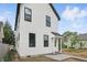 Attractive two-story home featuring white siding, black trim, and a covered entryway, complemented by a well-maintained yard at 1231 Marlowe Ave, Indianapolis, IN 46202