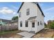 Charming two-story home featuring white siding, black trim, and a covered entryway, complemented by a well-maintained yard at 1231 Marlowe Ave, Indianapolis, IN 46202