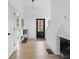 Bright foyer with hardwood floors, coat rack, and black front door, leading to a cozy interior at 1231 Marlowe Ave, Indianapolis, IN 46202