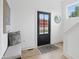 Inviting foyer featuring a black front door, bench seat, hardwood floors, and a decorative mirror at 1231 Marlowe Ave, Indianapolis, IN 46202