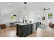 Open concept kitchen, dining and living space featuring a kitchen island with seating and modern design at 1231 Marlowe Ave, Indianapolis, IN 46202