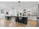 Open concept kitchen with island seating, modern appliances, hardwood floors, and plenty of natural light at 1231 Marlowe Ave, Indianapolis, IN 46202