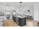 Modern kitchen with large island, stainless steel appliances, granite countertops, and natural lighting at 1231 Marlowe Ave, Indianapolis, IN 46202