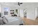 Bright main bedroom with ensuite bathroom, wood floors, ceiling fan, and large windows at 1231 Marlowe Ave, Indianapolis, IN 46202