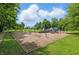 Community playground surrounded by mature trees and lush greenery, offering a safe and fun environment for children at 1231 Marlowe Ave, Indianapolis, IN 46202