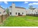 Exterior of a two-story home with a fenced backyard, showcasing a wooden deck and a chimney at 12422 River Valley Dr, Fishers, IN 46037