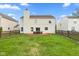 Backyard view of a two-story home with a wooden deck and grassy lawn, perfect for outdoor enjoyment at 12422 River Valley Dr, Fishers, IN 46037