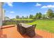 The backyard boasts a large wooden deck perfect for relaxing with a table and chairs surrounded by green grass at 12422 River Valley Dr, Fishers, IN 46037