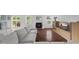 Comfortable living room with hardwood floors, neutral sofa, fireplace, and sliding door access to the deck at 12422 River Valley Dr, Fishers, IN 46037