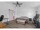 Spacious main bedroom with light gray walls, vinyl floors, a ceiling fan, and a sliding barn door to the bathroom at 12422 River Valley Dr, Fishers, IN 46037