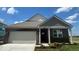 Charming single-story brick home featuring a two-car garage and neatly landscaped front yard at 1266 Foxtail Ln, Greenwood, IN 46143